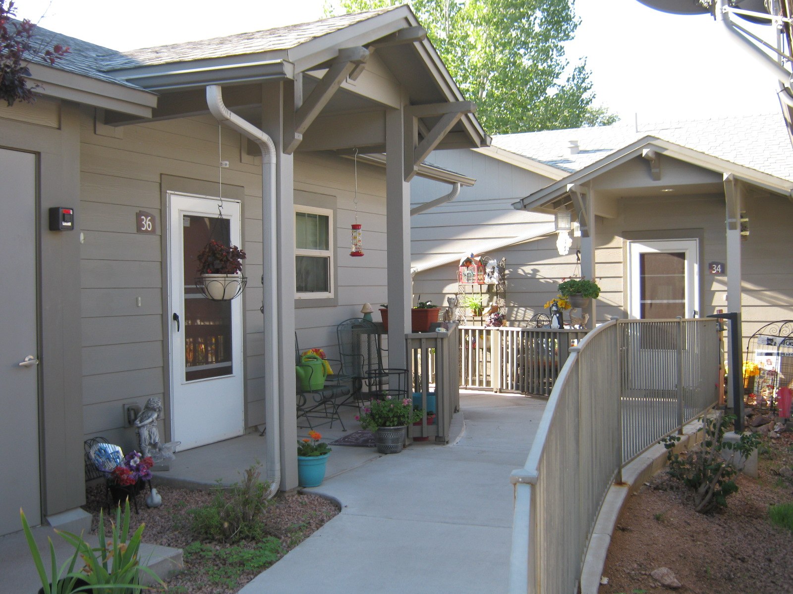 A small building with a white door and a porch.